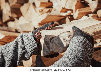 Man stacking firewood, prepares for cold winter, toned photo. Heating home with firewood in countryside during winter - Shutterstock ID 2354707673