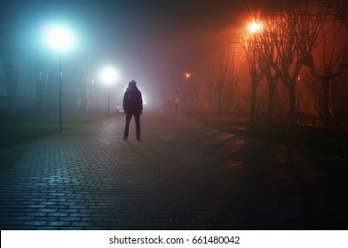 man stand alone at the foggy street