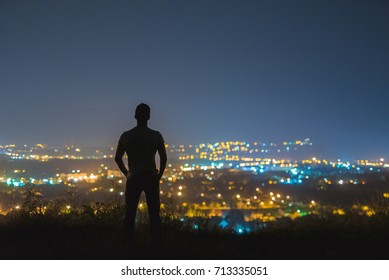 The Man Stand On The Background Of The City Lights. Night Time
