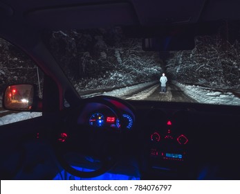 The man stand on the forest road near the car. inside view. evening night time - Powered by Shutterstock