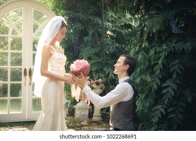 Man Stand On Knee With Flower Make A Proposal To Get Married To Beautiful Girlfriend, Engagement Concept