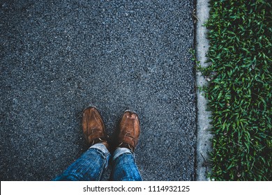 Man stand on side walk and shade of shadow