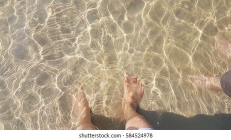 Man Stand In The Sea With Water Wave And Glitter Hot Sunshine On The  Beach Background