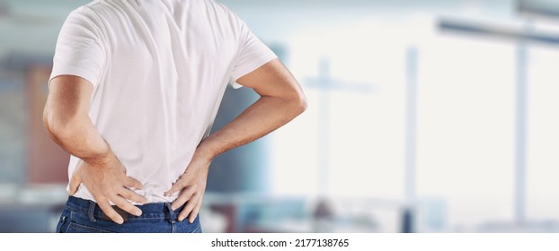 Man Stand, Touch Lower Back, Suffer From Sudden Backache, Due To Uncomfortable Chair. Sedentary Work Disease, Rheumatism, Low-back Lumbar Pain Illness Concept