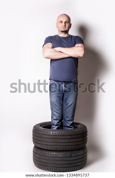 man standing
in automobile tires .changing
time