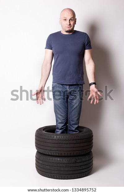 man standing
in automobile tires .changing
time
