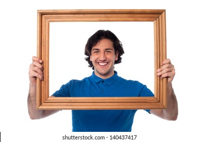 Man Standing Behind Wooden Picture Frame