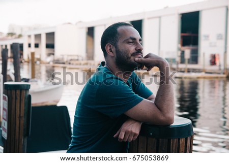 Man Standing by the Dock