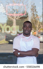 Man Standing By Frozen Yogurt Store