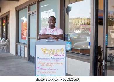 Man Standing By Frozen Yogurt Store