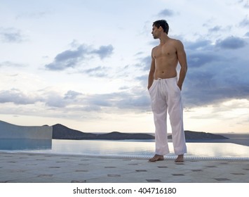 A man standing by a pool
