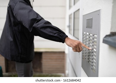 Man Standing At The Entrance Of The House Ringing The Door Bell
