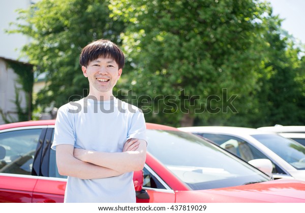 Man standing in front of\
car