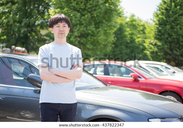 Man standing in front of
car