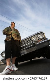 Man Standing In Front Of Car Low Angle View