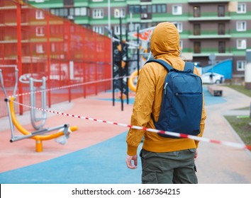 Man Standing In Front Of Fenced Outdoor Gym. Coronavirus Or Covid 19 Quarantine