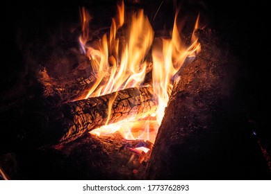 A man standing in front of a fire