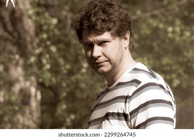 a man standing in front of a forest