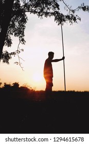 A man standing in front of the sunset. 