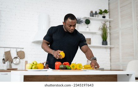 A man standing in front of a table filled with fruits and vegetables