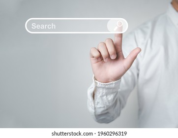 Man standing with hands pointing to information search is a data clicking to virtual internet search page computer touch screen. Education, Knowledge, Analysis the Internet to connect wirelessly. - Shutterstock ID 1960296319