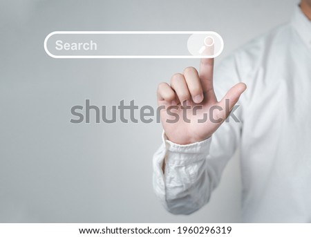 Man standing with hands pointing to information search is a data clicking to virtual internet search page computer touch screen. Education, Knowledge, Analysis the Internet to connect wirelessly.