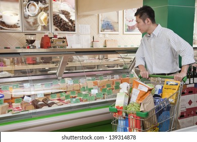 Man Standing And Looking At The Deli Counter, Beijing