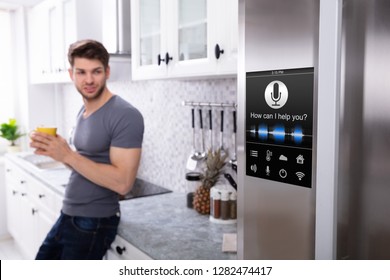 Man Standing Near Oven With Voice Recognition Function In Kitchen - Powered by Shutterstock