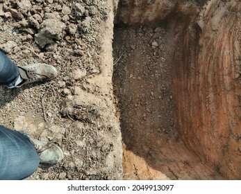 man standing near the underground tunnel, top view of hoe soil
