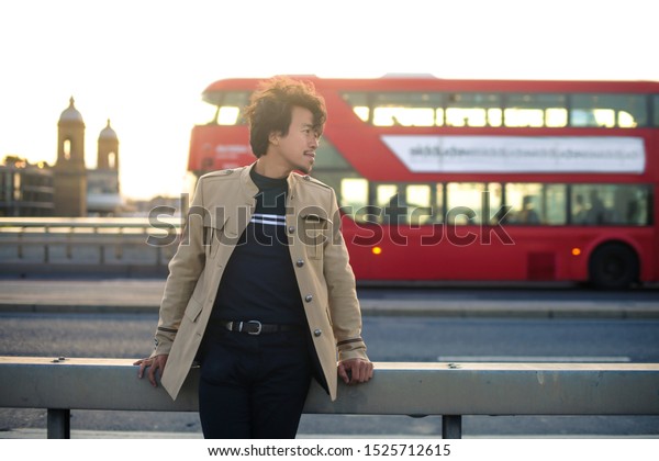Man standing on a bridge\
in london