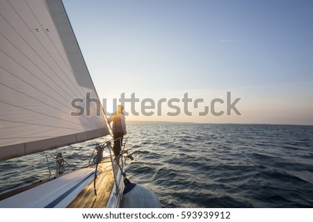 Man Standing On Front Of Luxury Yacht In Sea