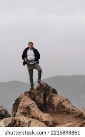 Man Is Standing On A High Viewpoint With Video Camera. High Quality Photo