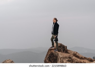 Man Is Standing On A High Viewpoint With Video Camera. High Quality Photo