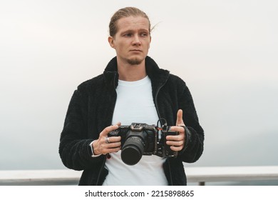 Man Is Standing On A High Viewpoint With Video Camera. High Quality Photo