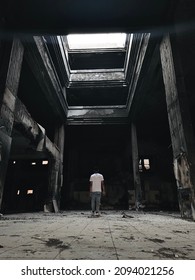 Man Standing On Old Burned Down Building