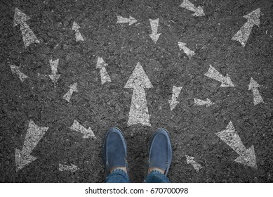 man standing on road with many direction arrow choices or move forward. concept solution and start.