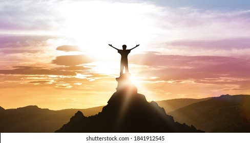 Man Standing On The Top Of A Mountain Looking At Beautiful Daybreak Mountains Landscape Outdoors. Set And Achieve Your Goal, Personal Achievement And Success, Motivational Background. Panorama
