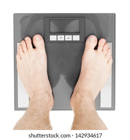 Man Standing On Weight Scales With Bare Foot - View From Top