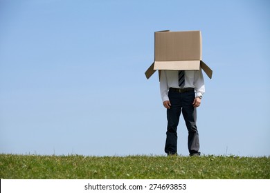 Man standing in park with cardboard box over his head - Shutterstock ID 274693853