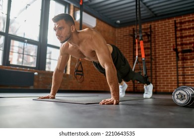 Man Standing In Plank Position On Arms