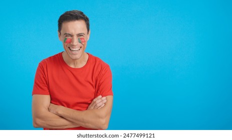 Man standing with portuguese flag painted on face smiling - Powered by Shutterstock