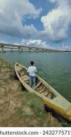 A Man Standing in a Small Boat on the Shore |River Godavari,Rajamundry,Andhra Pradesh,India|