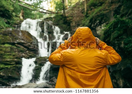 Similar – Foto Bild Mann in gelbem Regenmantel Wandern im Freien