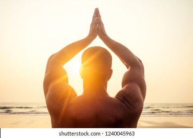 Man standing in yoga pose on ocean sunset paradise beach.Apollo athletic body, muscles - Powered by Shutterstock