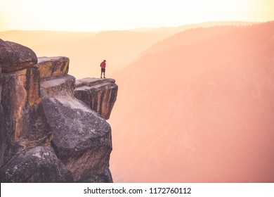 A Man Stands At The Edge Of A Cliff At Taft Point,Yosemite National Park, California.