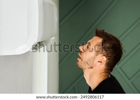 Similar – Image, Stock Photo Man Escaping Heat Under Air Conditioner