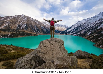 a man stands on a mountain, a mountain lake.Big Almaty Lake, Kazakhstan, Almaty