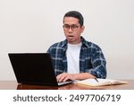 A man staring his laptop with shocked expression