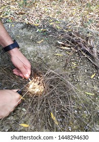 Man Starting Fire With Magnesium Fire Striker