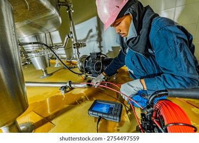 A man starts using a weld pipe stainless inspection camera. The light monitor shows images from the camera head that the inspector is